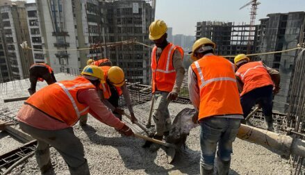 Construction crew finishing a concrete slab