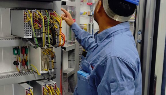 Electrician working on a control panel