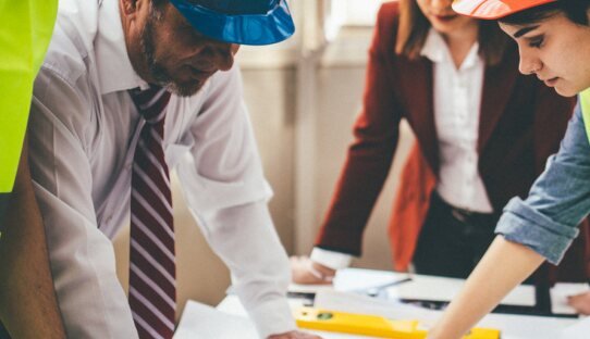 Engineers reviewing construction drawings