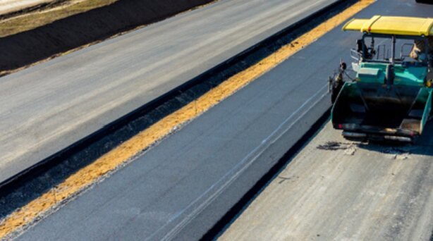 Asphalt paver laying a new road