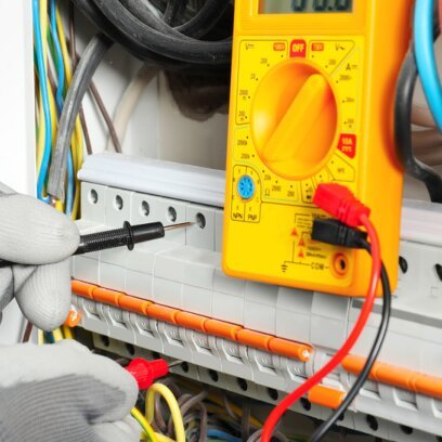 Electrician testing circuits with a multimeter