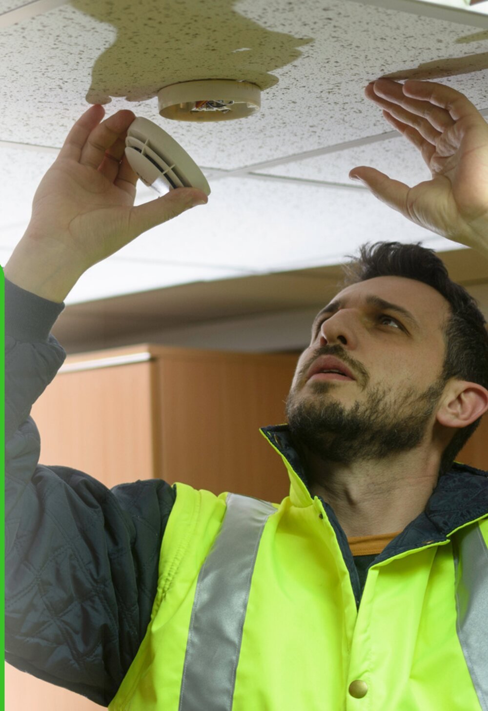 Technician installing a smoke detector