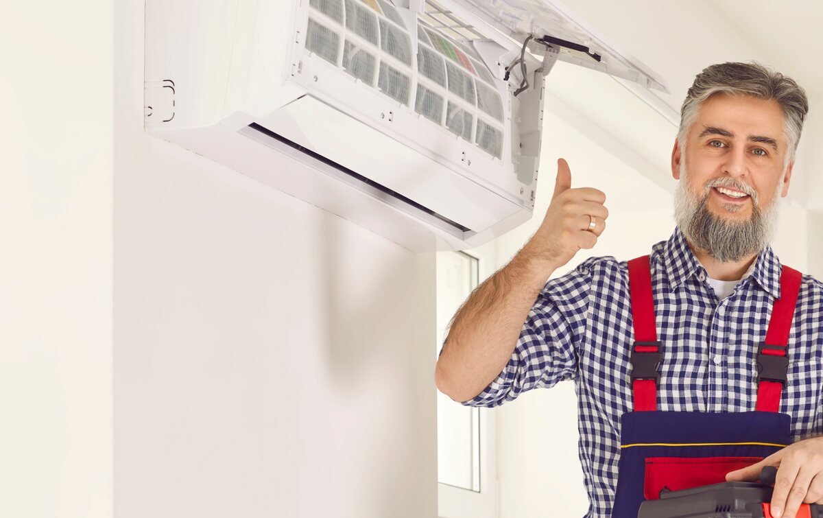 HVAC technician after servicing a split air conditioner