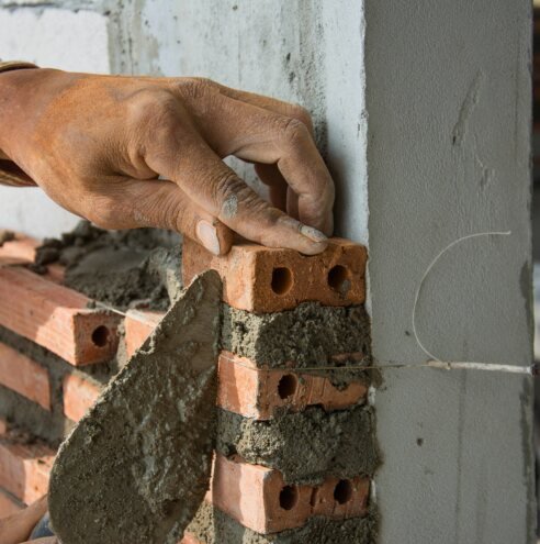 Mason laying bricks