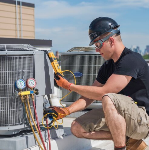 HVAC technician servicing an outdoor unit