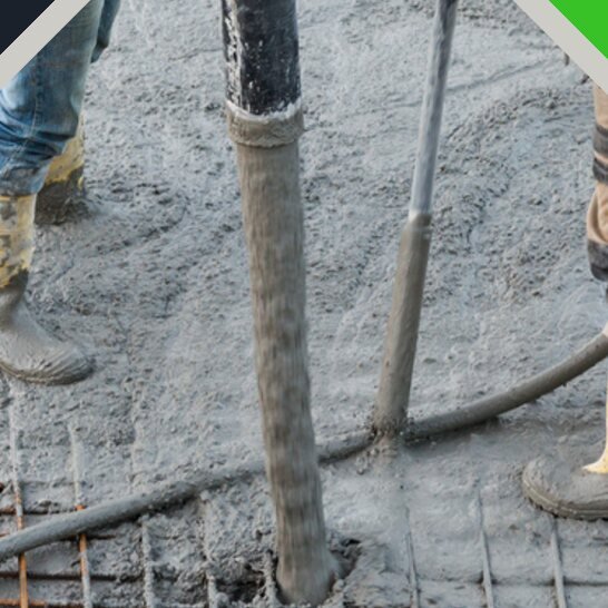 Concrete being poured over steel reinforcement