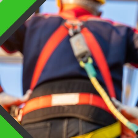 Worker wearing a fall protection harness